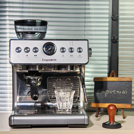 Empstorm espresso machine on a counter with a small stand and tamper in the background.