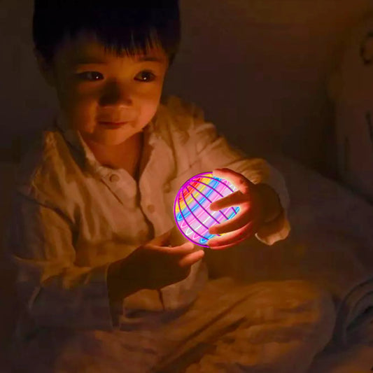 Child holding a colorful glowing ball in a dimly lit room